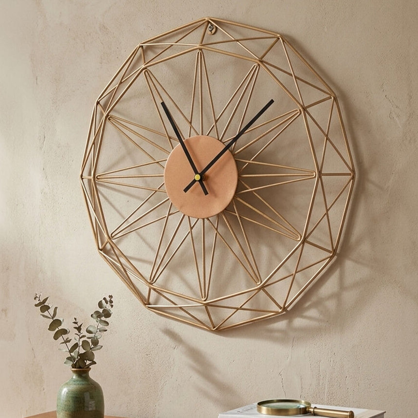 Geometric wall clock on a neutral wall with a wooden shelf below