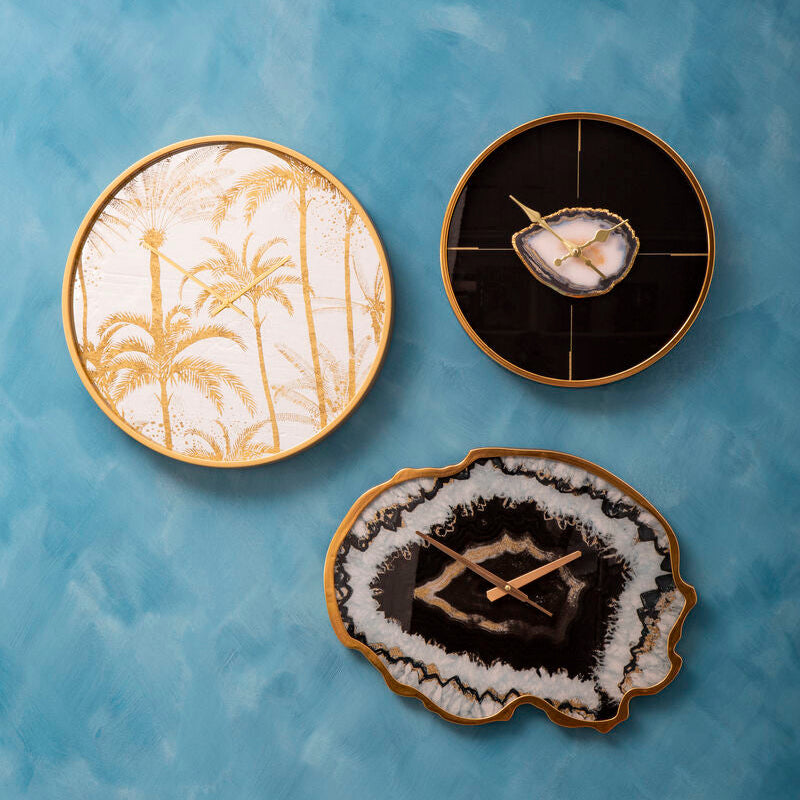 Three decorative coasters with different designs on a blue textured surface