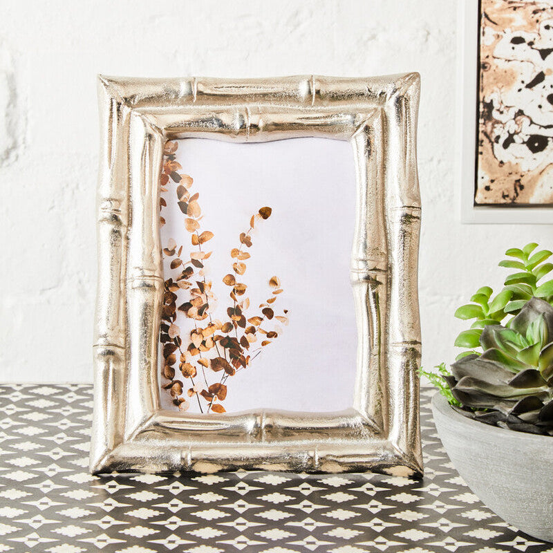 Silver picture frame with a floral print on a decorative table