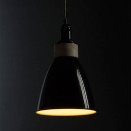 Black pendant light against a dark background