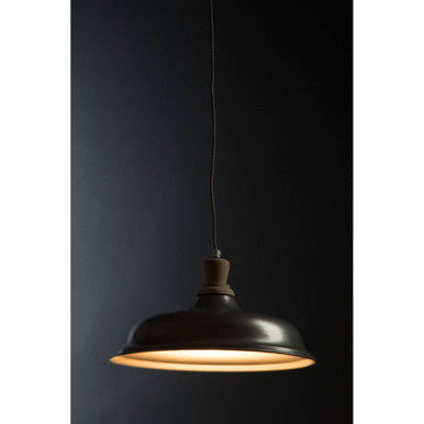 Black pendant light against a dark background