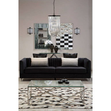 Modern living room with black sofa, glass coffee table, and decorative mirrors.