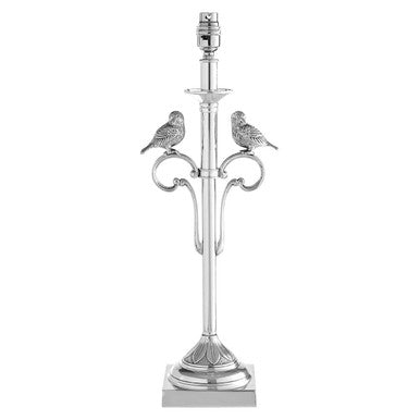 Decorative silver lamp with bird designs on a white background