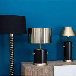 Set of four lamps on a wooden console against a blue wall