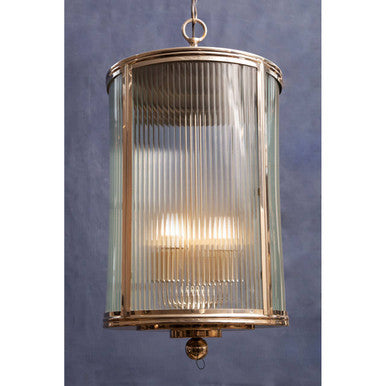Decorative pendant light with ribbed glass shade on a plain background