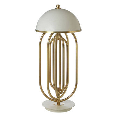 Table lamp with gold metal base and white shade on a white background