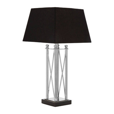 Table lamp with black shade and metallic base on a white background