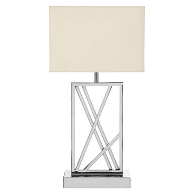 Table lamp with a metallic base and beige shade on a white background
