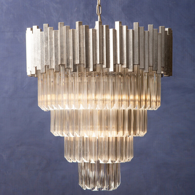 Chandelier with ribbed glass design against a textured blue wall