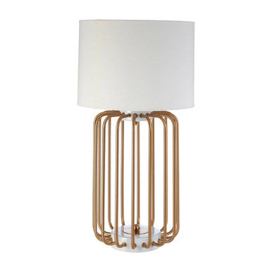 Table lamp with gold cage base and white shade on a white background