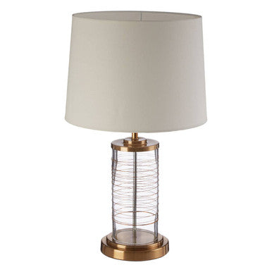 Table lamp with beige shade and brass base on a white background