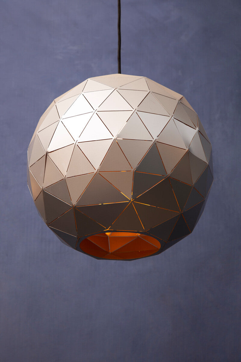 Geometric pendant light with a metallic finish on a dark background