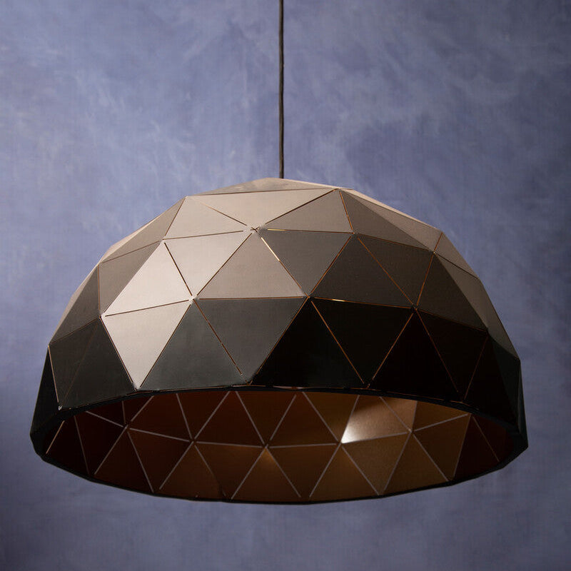 Geometric pendant light against a textured purple wall