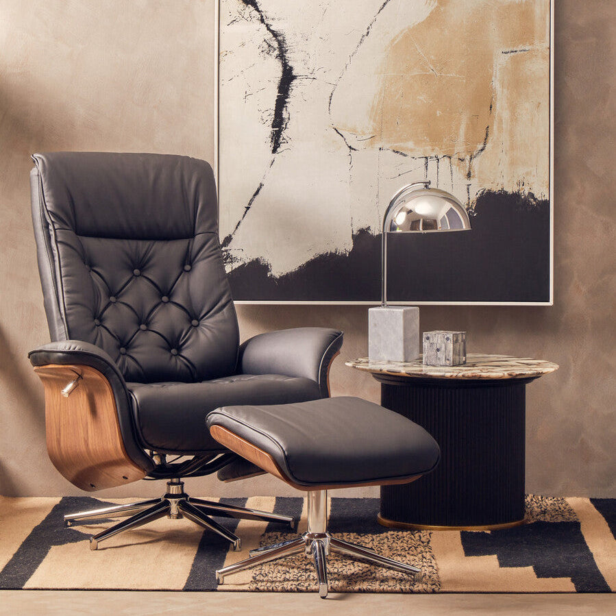 Leather armchair with ottoman in a room with abstract art on the wall.