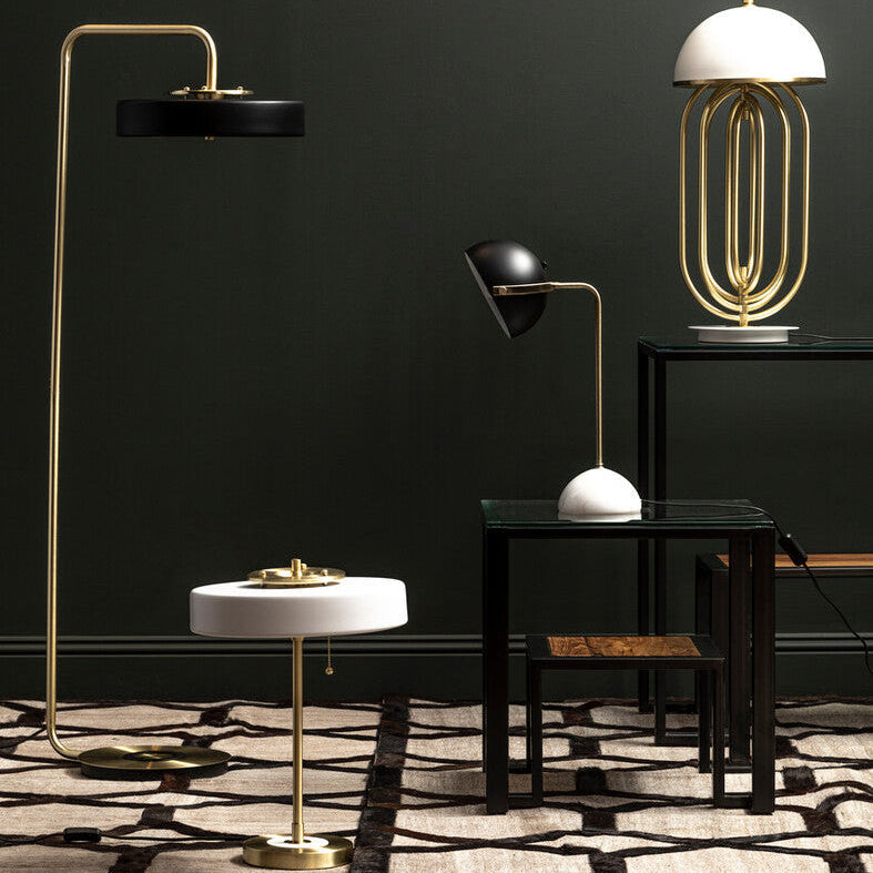 Modern interior with various lamps and a dark wall.