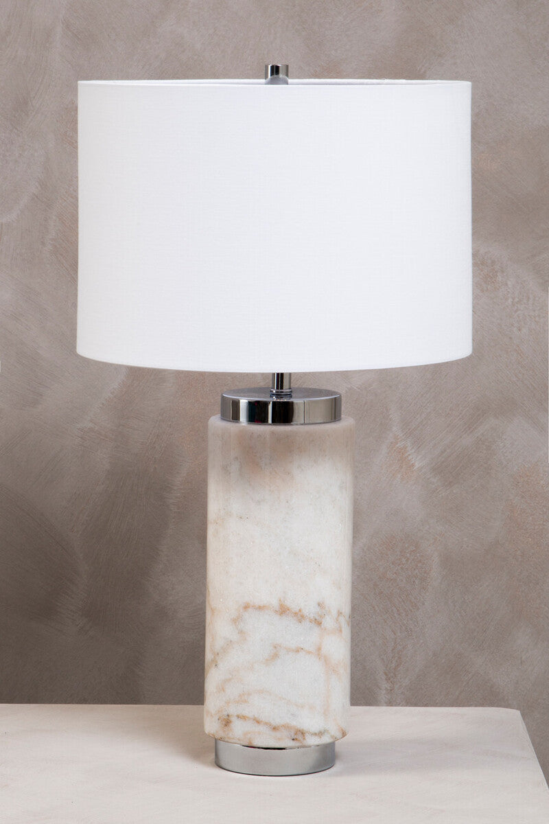 Table lamp with marble base and white shade on a neutral background