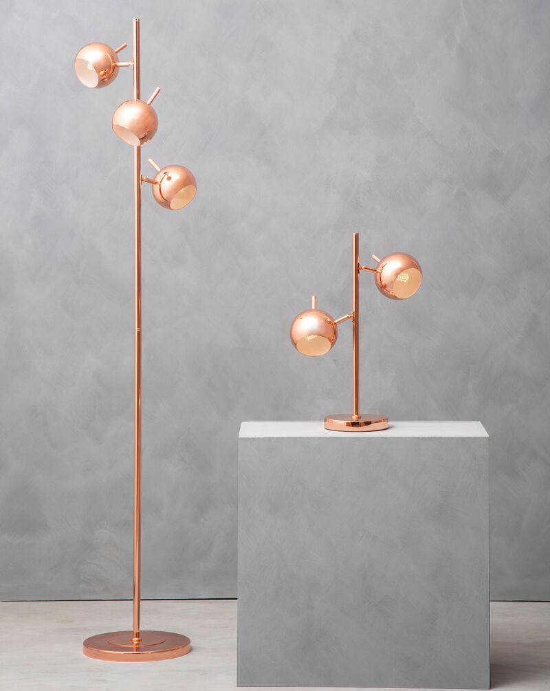 Copper floor lamp and table lamp on a gray surface with a gray background
