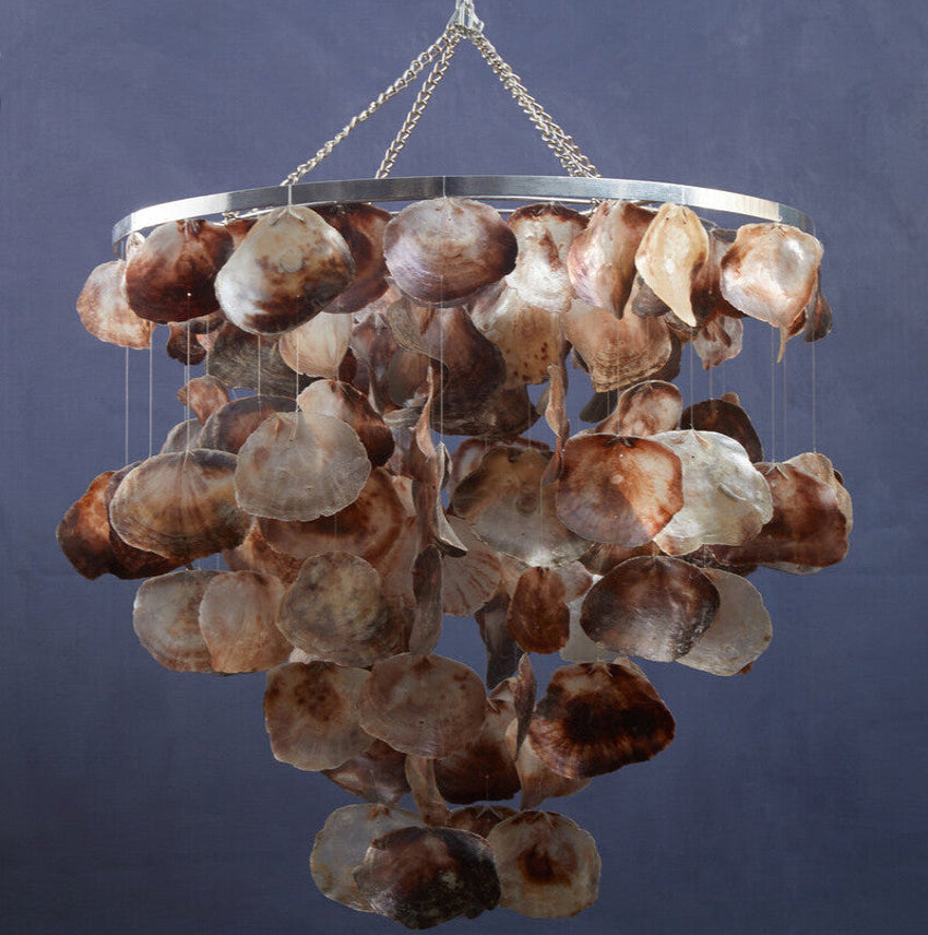 Chandelier made of shell-like materials against a dark background