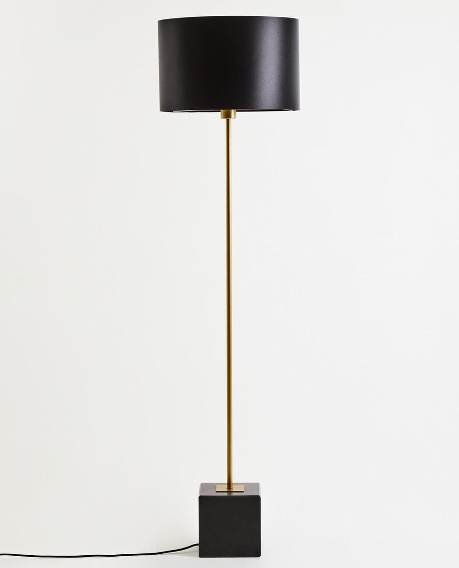 Black floor lamp with a square base on a white background