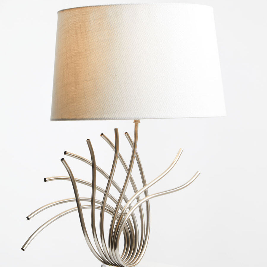Decorative table lamp with unique metal base on a white surface