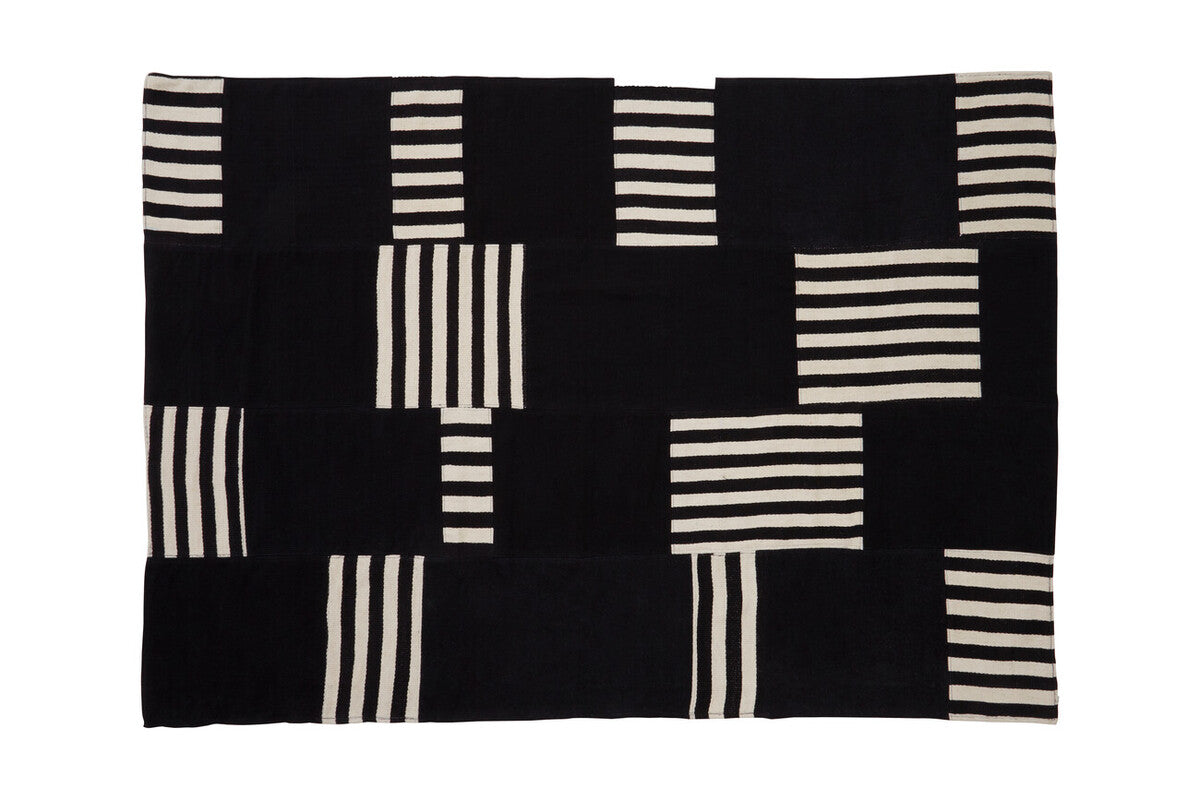 Black and white patterned rug on a white background