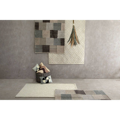 Rug with geometric pattern on a gray wall and floor