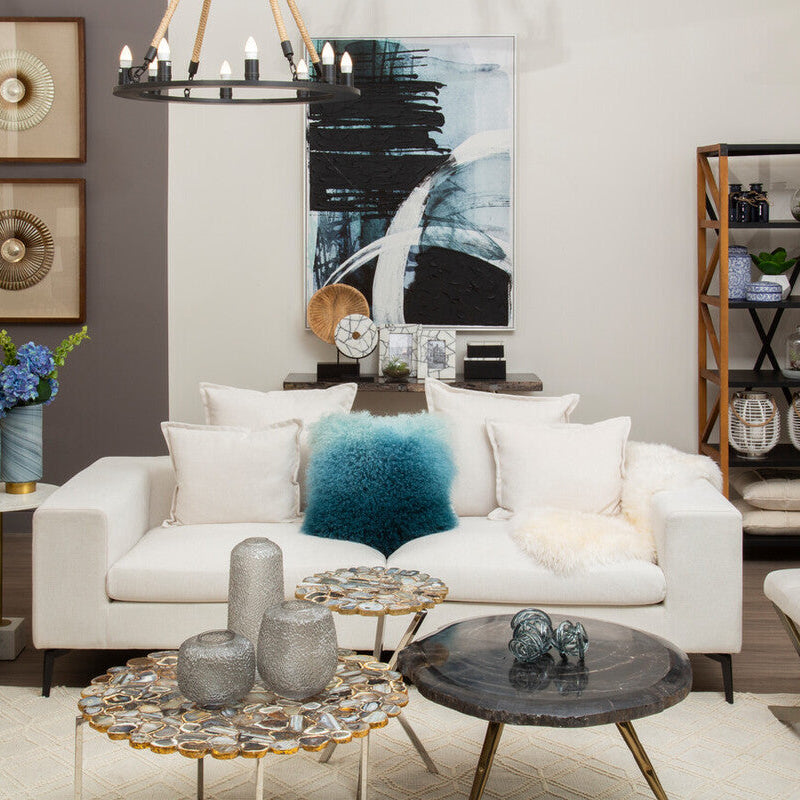 Modern living room with white sofa, decorative pillows, and a coffee table.