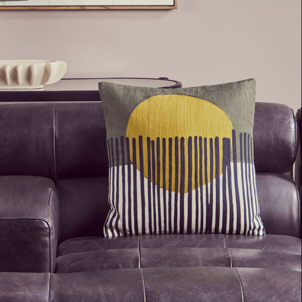 Modern living room with a gray sofa, abstract art, and decorative items.