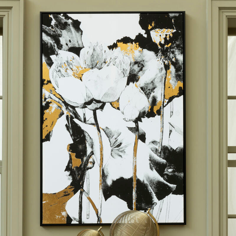 Framed abstract art piece with floral elements on a wall above a gold console table.