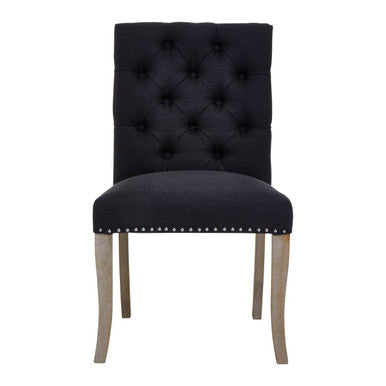 Black upholstered chair with wooden legs on a white background