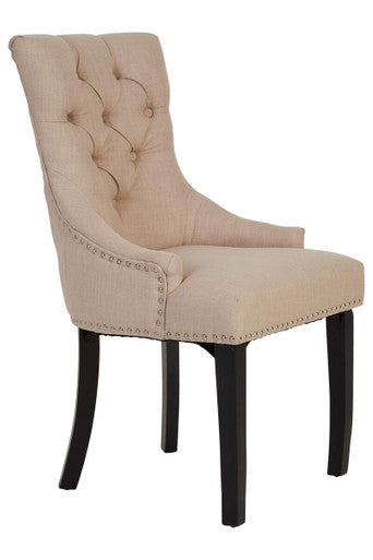Beige upholstered chair with black legs on a white background