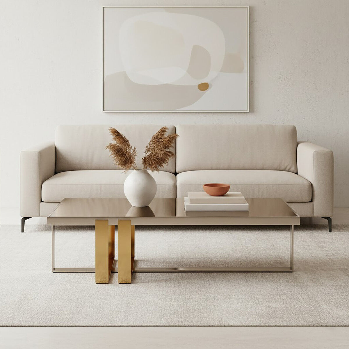 Modern living room with a beige sofa, gold coffee table, and abstract art on the wall.
