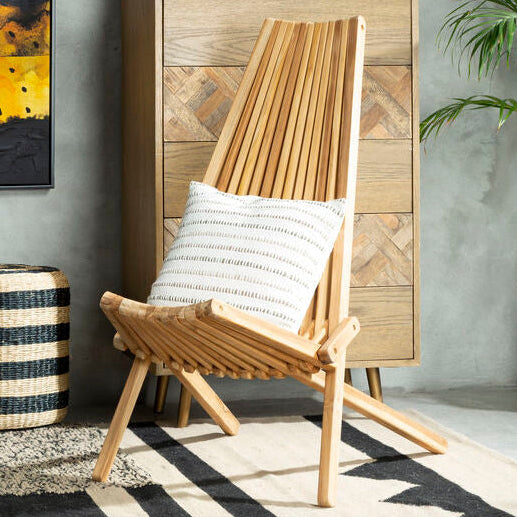 Wooden chair with a striped pillow in a room with abstract art, a cabinet, and plants.