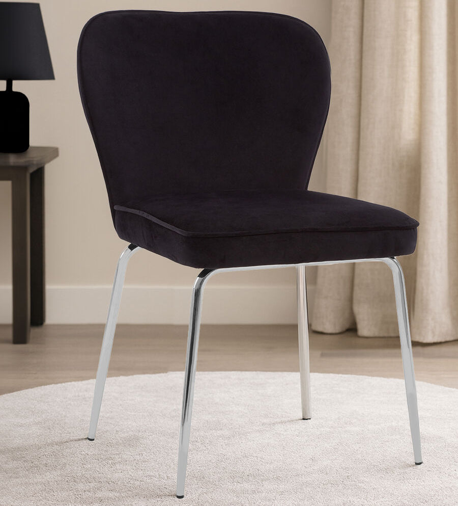 Black upholstered chair with silver legs on a round beige rug in a room setting.