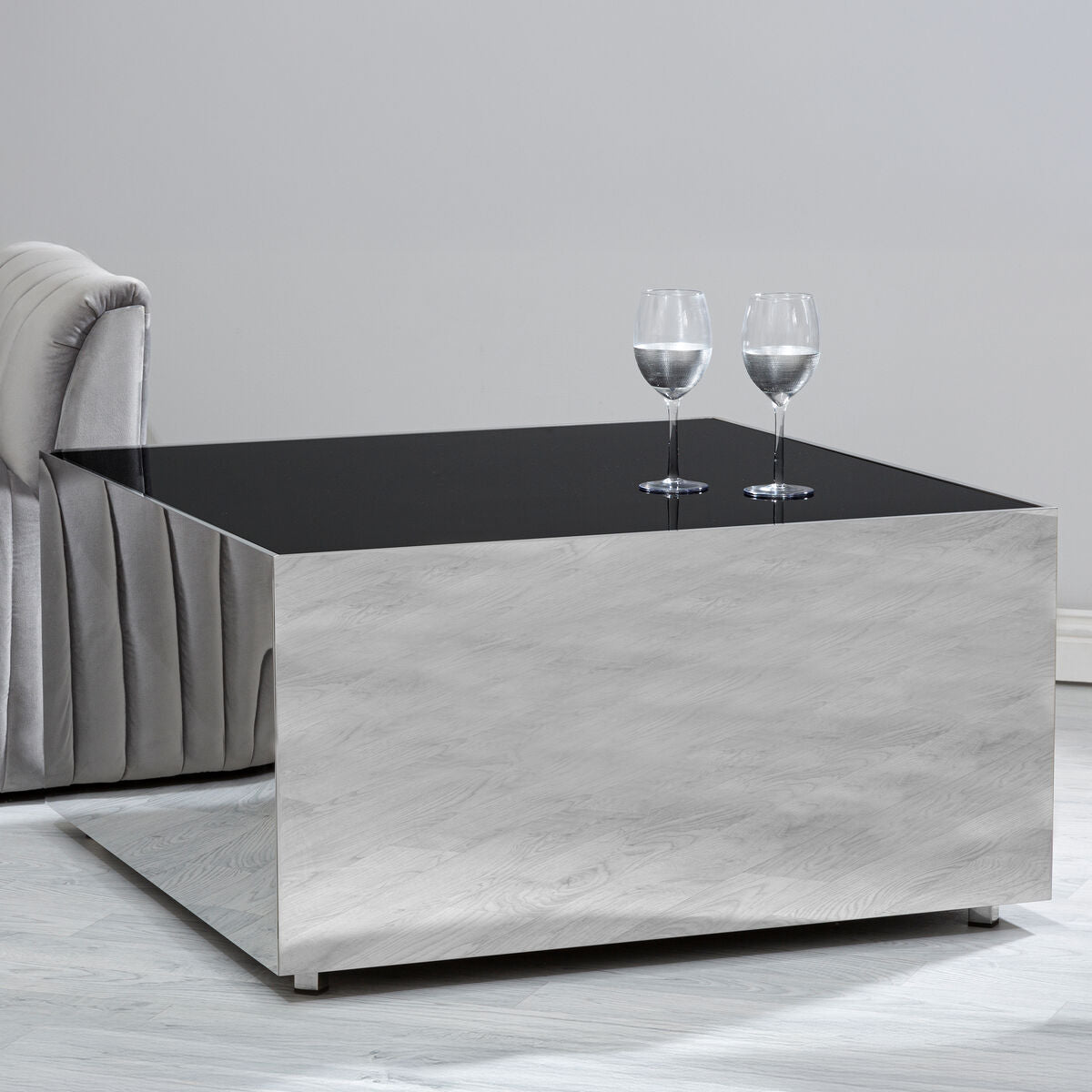 Coffee table with a black top and gray base in a room setting