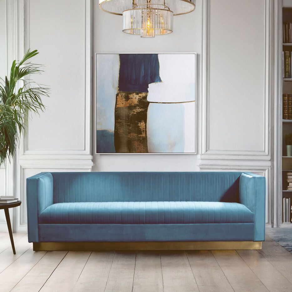 Blue sofa in a stylish living room with a mirror and chandelier.