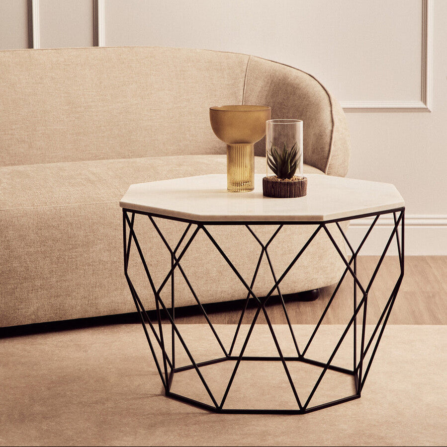 Modern coffee table with geometric design in a living room setting.