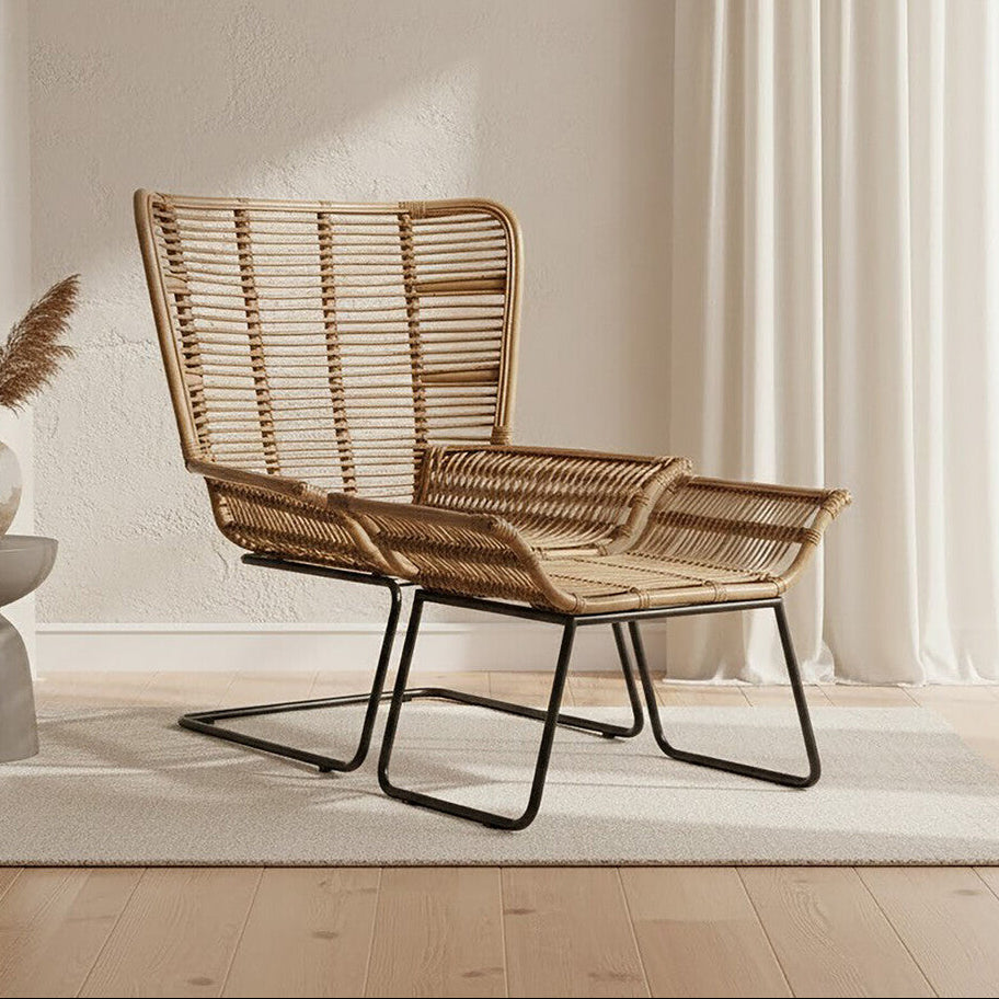 Woven chair in a minimalistic room with light-colored walls and wooden floor.