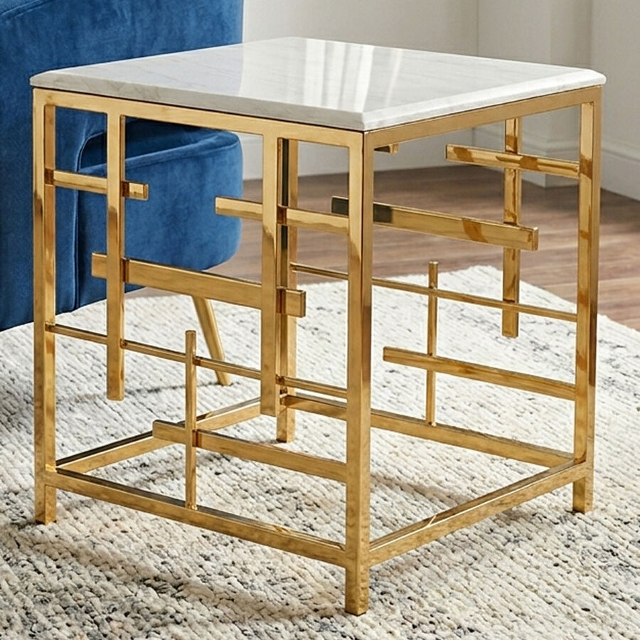 Gold side table with marble top next to a blue chair in a room.