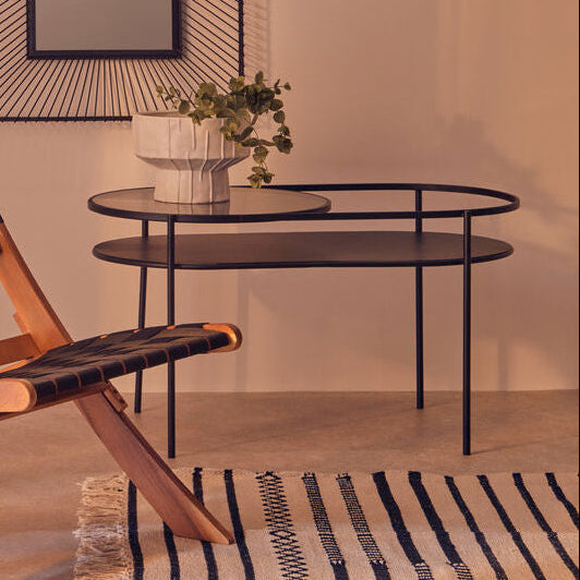 Modern chair with woven backrest in a room with a mirror and small table.