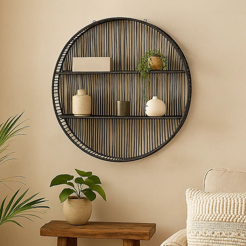 Round woven wall shelf with decorative items in a living room setting.