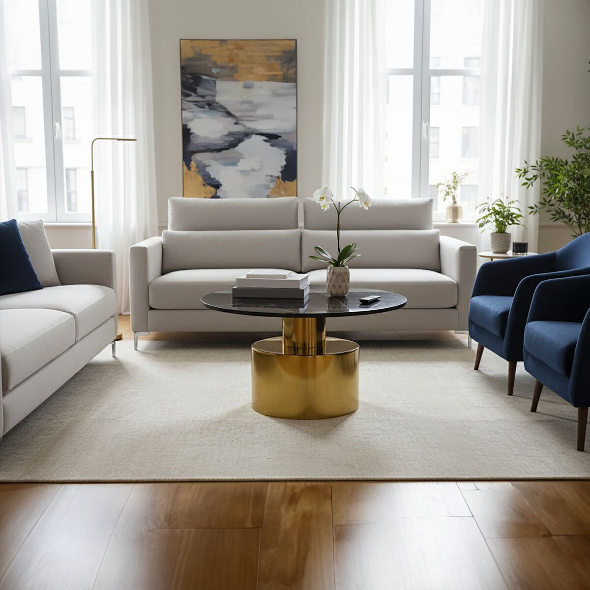 Modern living room with a white sofa, gold coffee table, and abstract art on the wall.