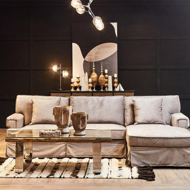 Modern living room with a gray sectional sofa, wooden coffee table, and decorative items.
