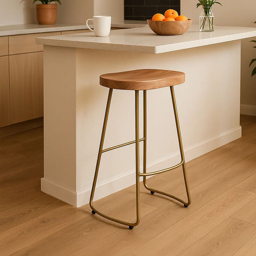 Kitchen island with a wooden stool, potted plants, and a bowl of fruit.