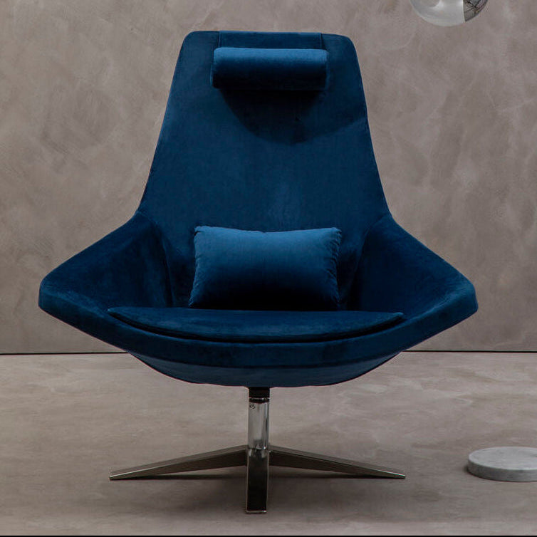 Blue armchair with a floor lamp against a textured wall.