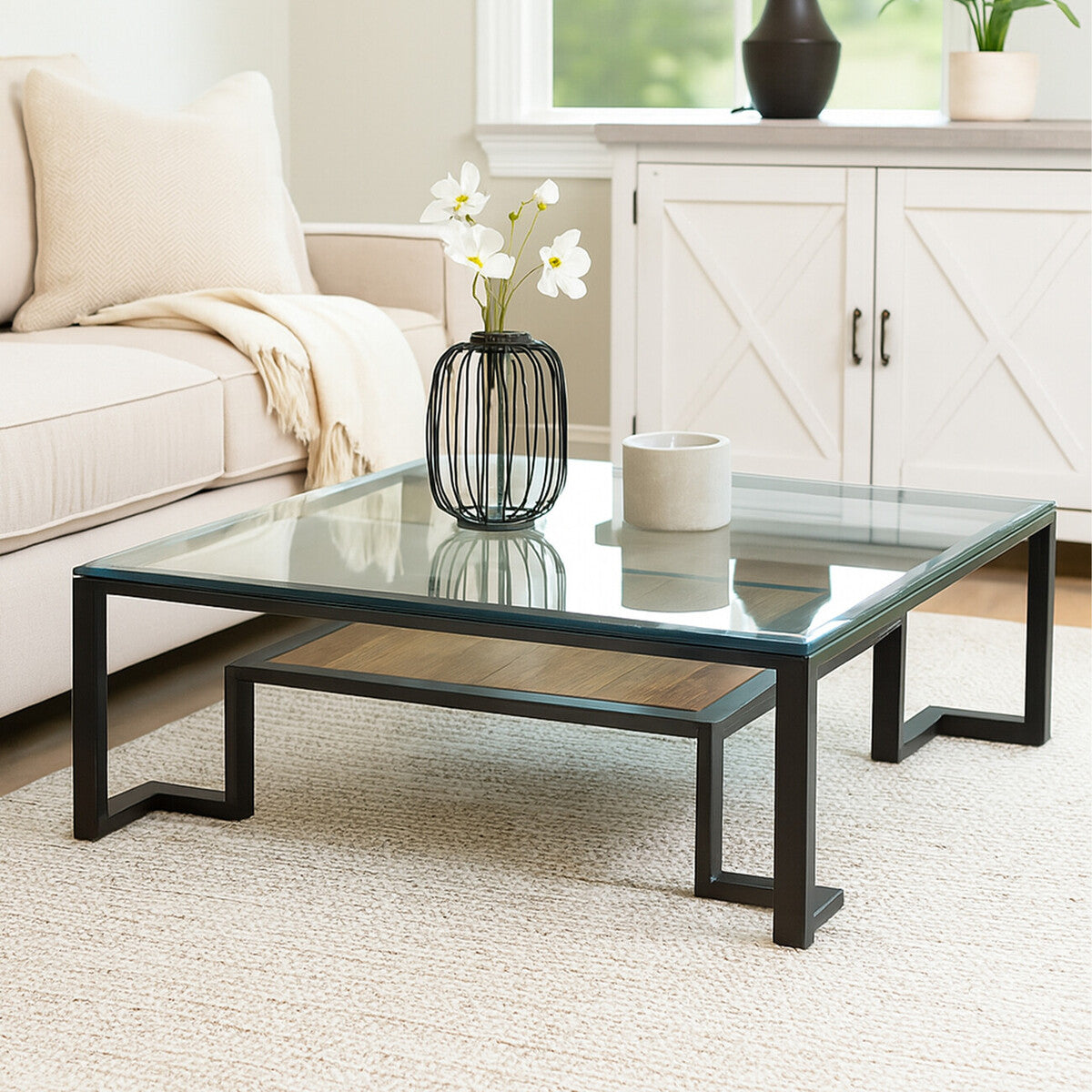 Glass coffee table with black metal frame in a living room setting