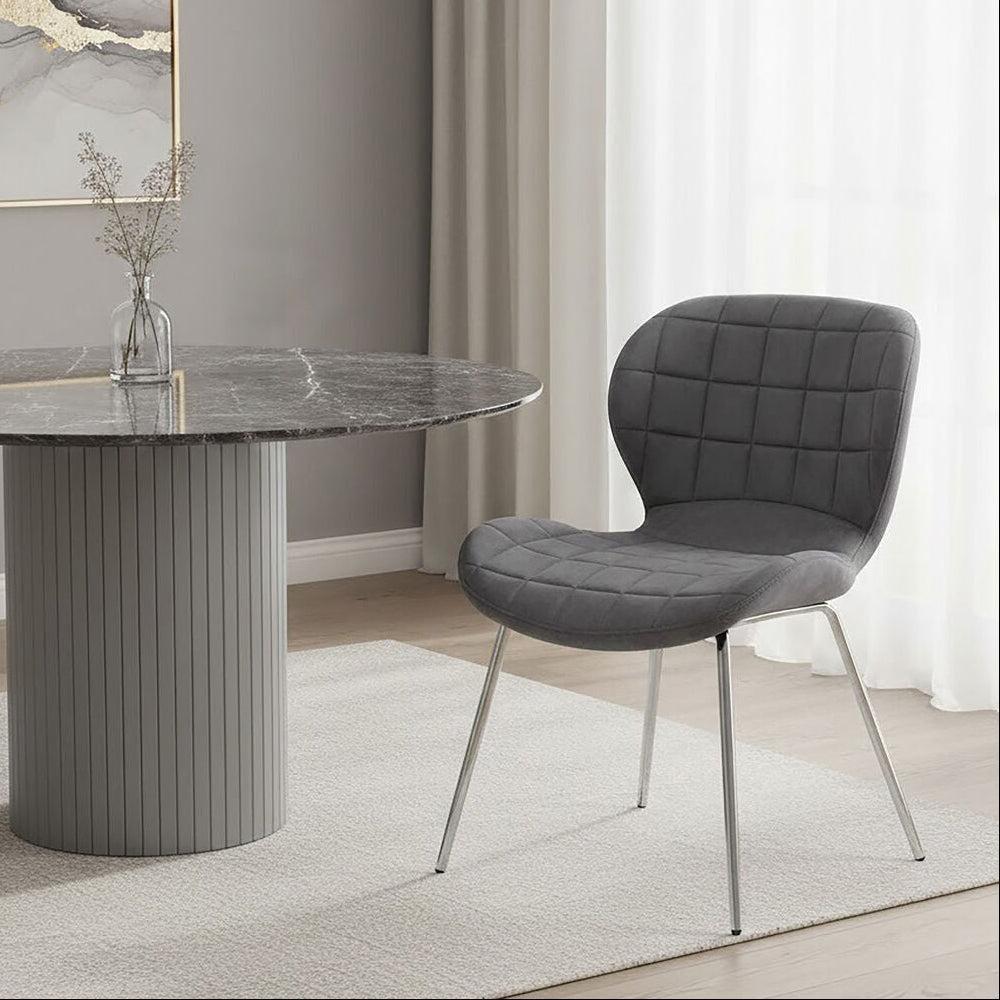 Dining room with a gray marble table and chair in a modern interior setting.