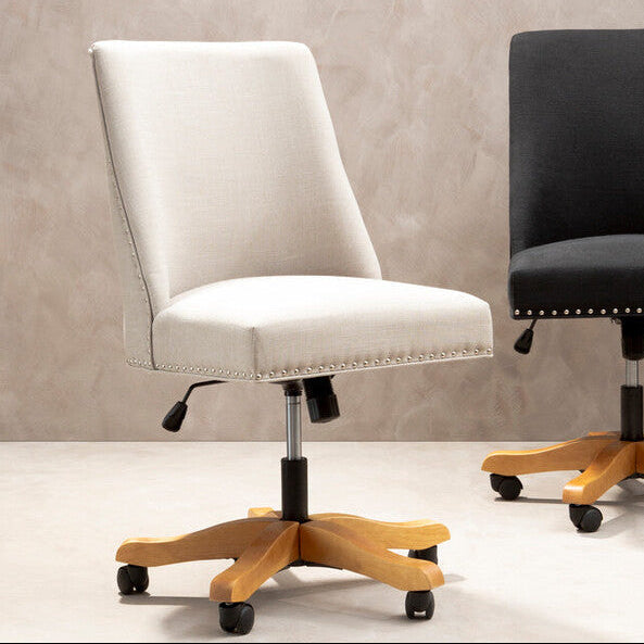 Two office chairs, one white and one black, on a neutral background