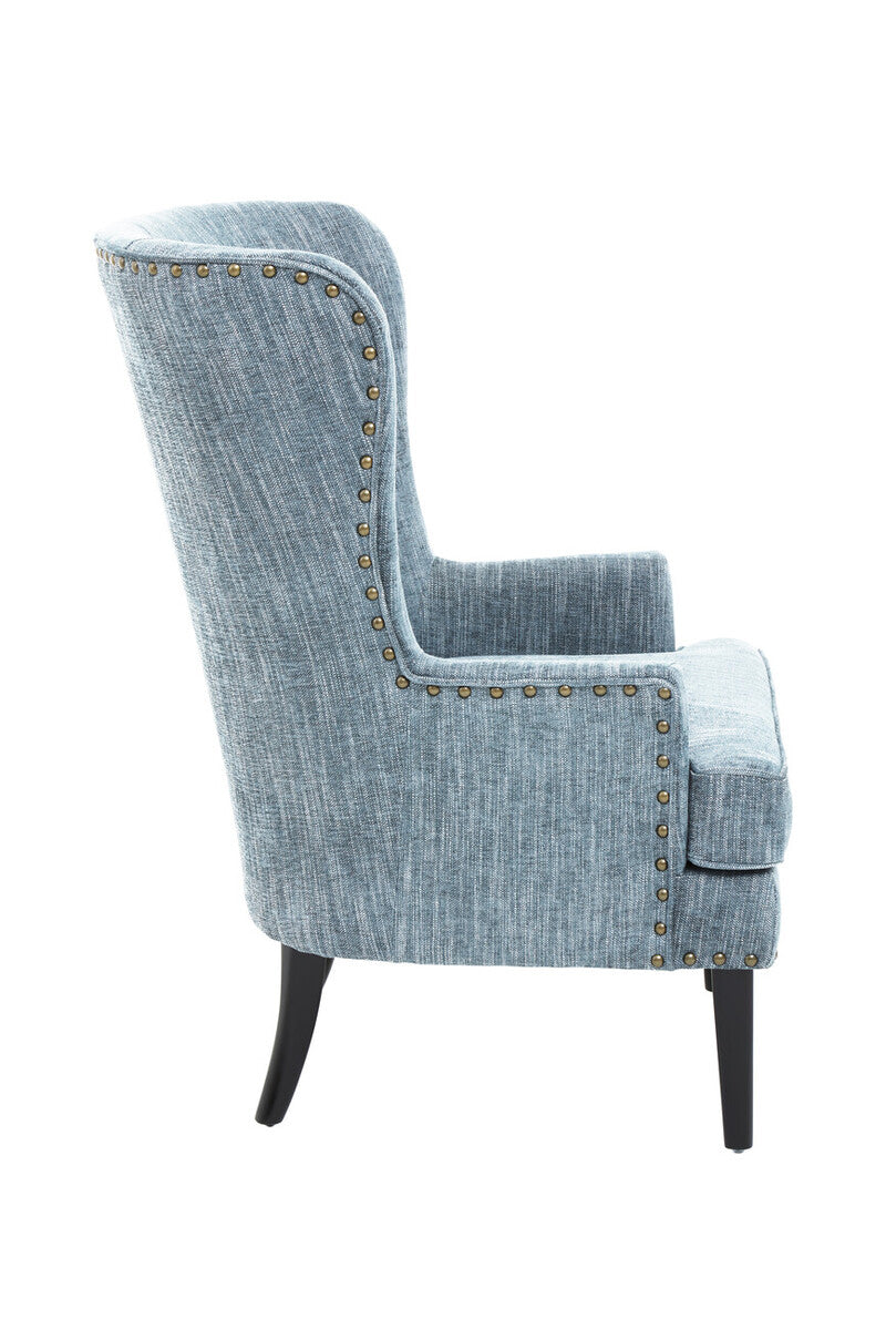 Blue upholstered chair with studded details on a white background