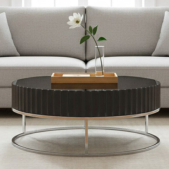 Modern living room with a gray sectional sofa and round black coffee table.